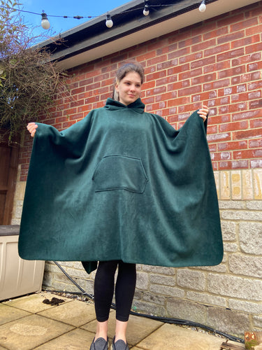 Girl wearing a green hooded blanket scout camp blanket badge blanket with pocket