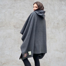 Load image into Gallery viewer, Girl with her back to the photo wearing grey hooded blanket camp blanket badge blanket with scout badges sewn on
