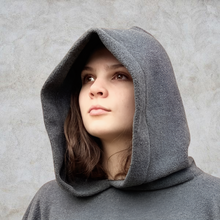 Load image into Gallery viewer, Girl wearing grey hooded blanket camp blanket badge blanket 
