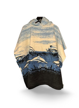 Load image into Gallery viewer, hooded fleece blanket poncho with a pocket in a dolphin and seascape design in blue
